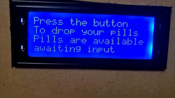 Dispenser screen reading: press the button to drop your pills